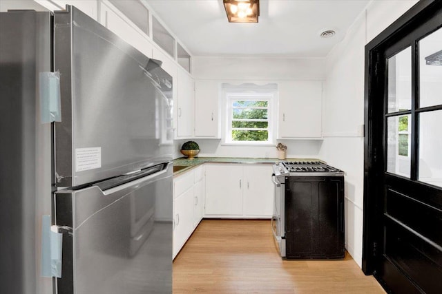 4 Cedar St, Hastings-On-Hudson, NY 10706 - kitchen with stainless steel appliances, light wood finished floors, and white cabinets