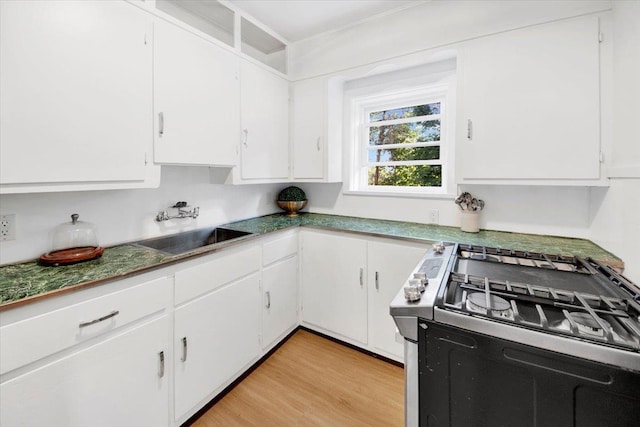 4 Cedar St, Hastings-On-Hudson, NY 10706 - kitchen with gas stove, white cabinets, and light wood finished floors