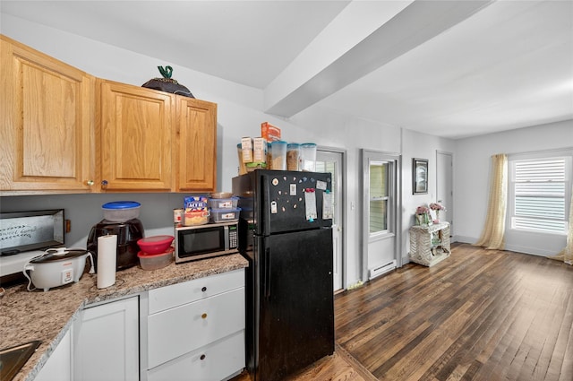 33 E Main St, Blooming Grove, NY 10992 - kitchen with freestanding refrigerator, stainless steel microwave, wood finished floors, baseboard heating, and light stone counters