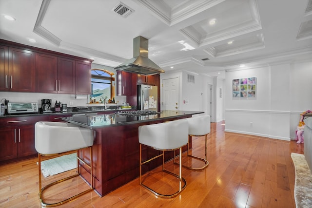 4048 194th St Unit A3, Flushing, NY 11358 - kitchen featuring island exhaust hood, dark brown cabinets, appliances with stainless steel finishes, dark countertops, and crown molding