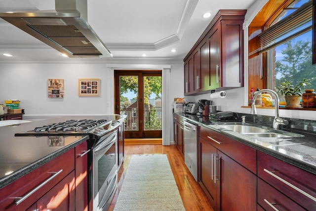 4048 194th St Unit A3, Flushing, NY 11358 - kitchen featuring stainless steel appliances, wall chimney exhaust hood, crown molding, reddish brown cabinets, and light wood finished floors