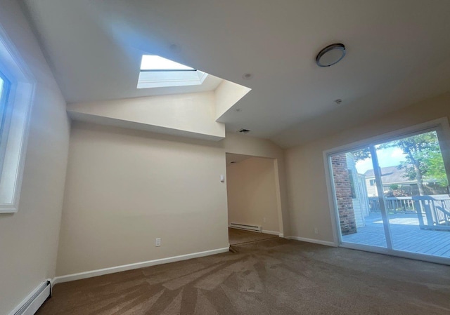 181 Wading River Hollow Rd, Ridge, NY 11961 - empty room with a baseboard radiator, lofted ceiling, a baseboard heating unit, a skylight, and carpet flooring