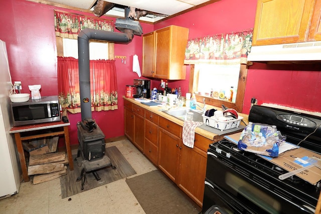 11620 State Route 97, Long Eddy, NY 12760 - kitchen with black range, under cabinet range hood, stainless steel microwave, light flooring, and light countertops