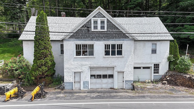 11620 State Route 97, Long Eddy, NY 12760 - view of front facade with roof with shingles, stucco siding, and an attached garage