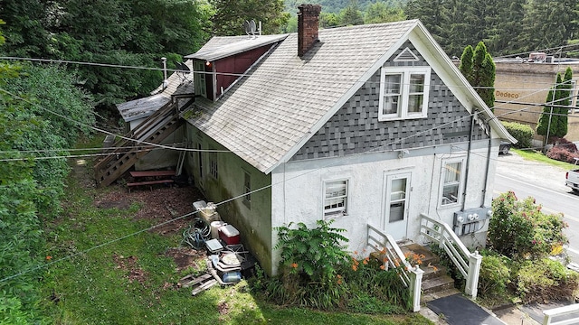 11620 State Route 97, Long Eddy, NY 12760 - view of front facade with a shingled roof, stucco siding, stairs, and a chimney