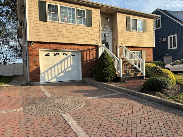 557 Southside Ave, Freeport, NY 11520 - bi-level home with brick siding, an attached garage, and decorative driveway
