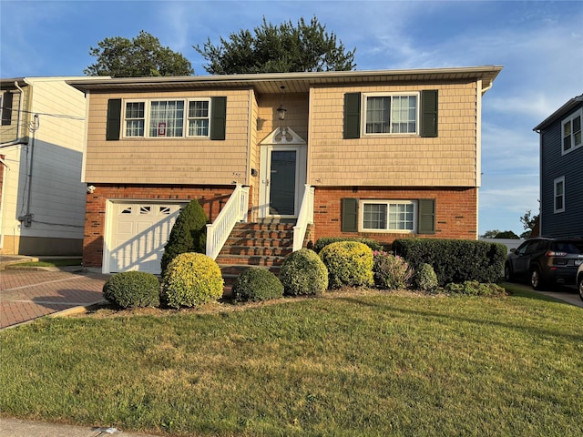 557 Southside Ave, Freeport, NY 11520 - raised ranch featuring brick siding, an attached garage, a front lawn, and decorative driveway