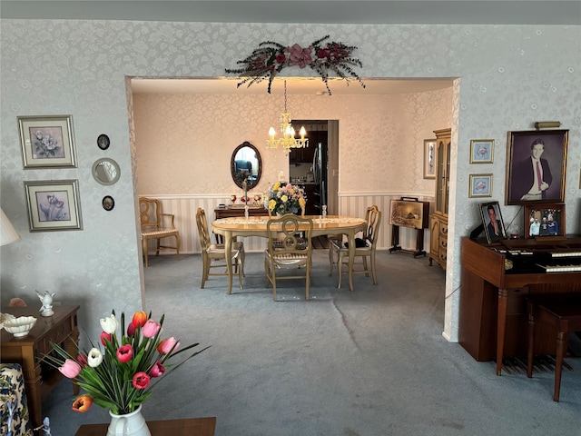 557 Southside Ave, Freeport, NY 11520 - carpeted dining space featuring a chandelier, wallpapered walls, and a wainscoted wall