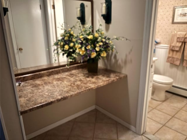 557 Southside Ave, Freeport, NY 11520 - bathroom featuring tile patterned floors and a baseboard heating unit