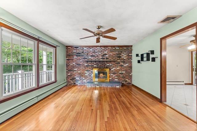 15 Glen Dr, South Salem, NY 10590 - unfurnished living room featuring a baseboard radiator, a ceiling fan, wood finished floors, and healthy amount of natural light