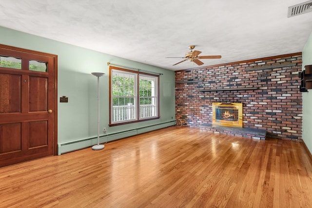 15 Glen Dr, South Salem, NY 10590 - unfurnished living room featuring a baseboard radiator, wood finished floors, a ceiling fan, and a fireplace