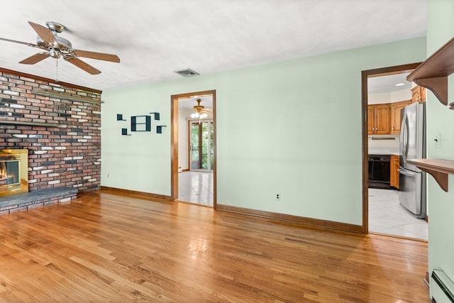 15 Glen Dr, South Salem, NY 10590 - unfurnished living room featuring ceiling fan, a baseboard radiator, and light wood-type flooring