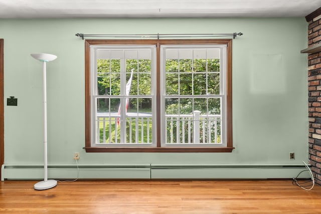 15 Glen Dr, South Salem, NY 10590 - detailed view of wood finished floors, brick wall, and baseboard heating