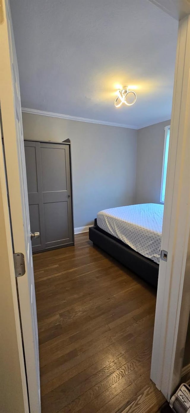 150-10 71st Ave Unit 2G, Kew Garden Hills, NY 11367 - bedroom featuring dark wood-style flooring and ornamental molding