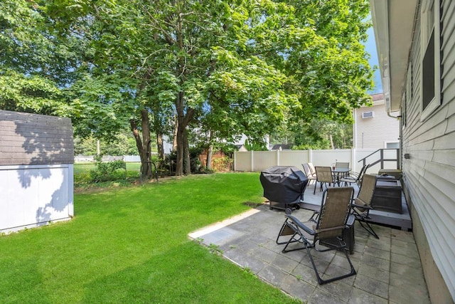 15 Halewood Dr, Shirley, NY 11967 - fenced backyard with a storage unit, outdoor dining area, and a patio area