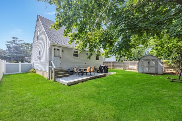 15 Halewood Dr, Shirley, NY 11967 - rear view of house with a shingled roof, entry steps, a fenced backyard, and a storage unit