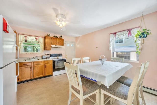 15 Halewood Dr, Shirley, NY 11967 - dining space with plenty of natural light, a ceiling fan, and a baseboard heating unit