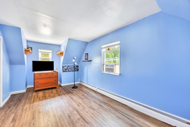 15 Halewood Dr, Shirley, NY 11967 - unfurnished living room featuring baseboard heating, vaulted ceiling, wood finished floors, and cooling unit