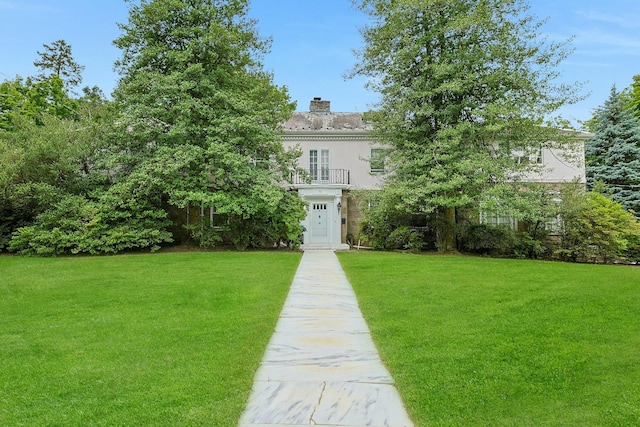 50 Forest Cir, New Rochelle, NY 10804 - georgian-style home with a chimney, a front lawn, and a balcony