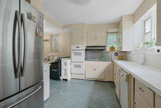 50 Forest Cir, New Rochelle, NY 10804 - kitchen with white appliances, under cabinet range hood, light countertops, and backsplash