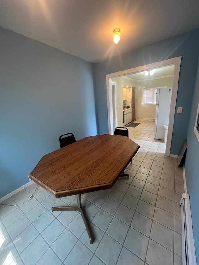 234 S 7th St, Lindenhurst, NY 11757 - dining area with light tile patterned floors and a baseboard heating unit