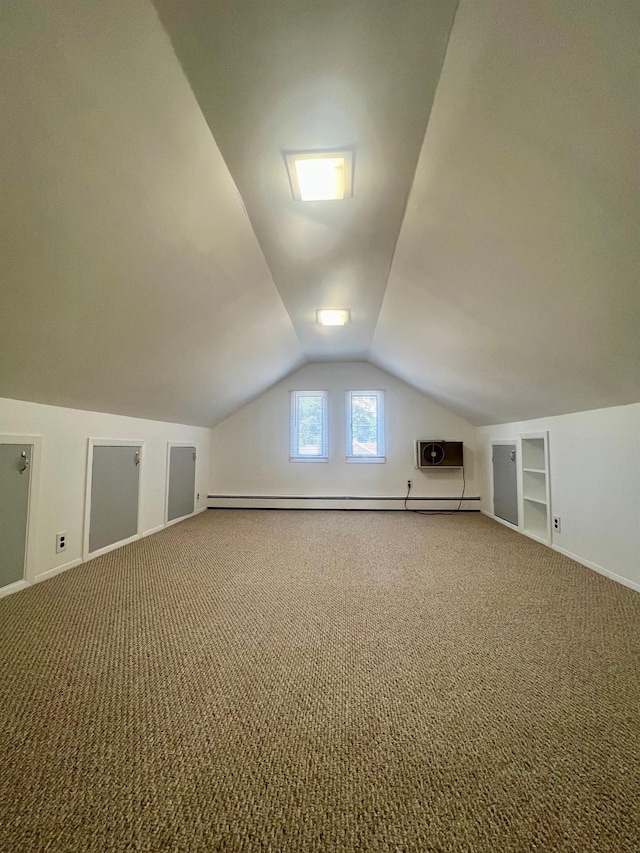 234 S 7th St, Lindenhurst, NY 11757 - bonus room featuring carpet, lofted ceiling, built in shelves, and a baseboard heating unit