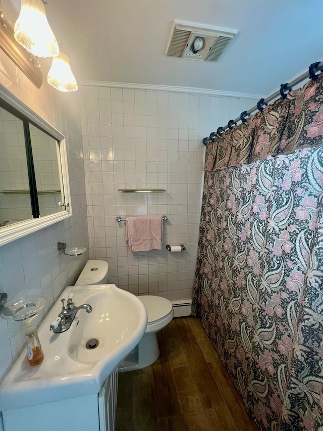 234 S 7th St, Lindenhurst, NY 11757 - bathroom with hardwood / wood-style flooring, tile walls, baseboard heating, and a shower with shower curtain