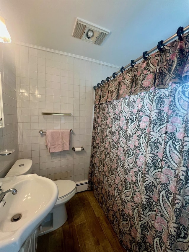 234 S 7th St, Lindenhurst, NY 11757 - full bath featuring hardwood / wood-style flooring, tile walls, a baseboard radiator, and a shower with curtain