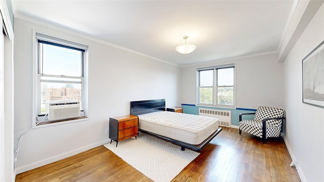 90-02 63rd Dr Unit 5J, Rego Park, NY 11374 - bedroom with radiator, wood finished floors, ornamental molding, and cooling unit