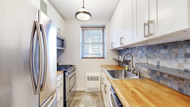 90-02 63rd Dr Unit 5J, Rego Park, NY 11374 - kitchen with stainless steel appliances, butcher block counters, backsplash, and white cabinetry