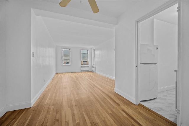 2102 Holland Ave Unit 6D, Bronx, NY 10462 - empty room featuring light wood-style floors, ceiling fan, and radiator