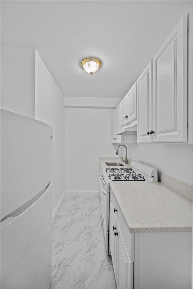 2102 Holland Ave Unit 6D, Bronx, NY 10462 - kitchen with white appliances, light marble finish flooring, white cabinetry, under cabinet range hood, and light stone countertops
