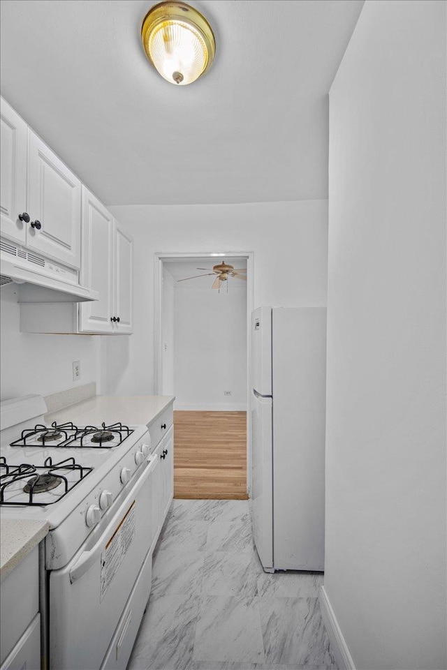 2102 Holland Ave Unit 6D, Bronx, NY 10462 - kitchen featuring white appliances, exhaust hood, light marble finish flooring, white cabinets, and light countertops