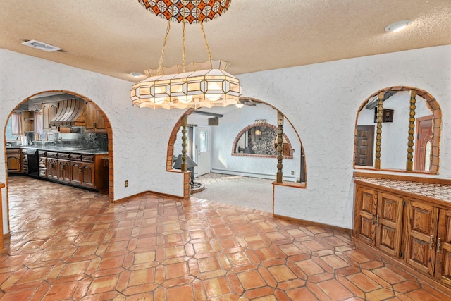 60 Wheatfield Ln, Commack, NY 11725 - unfurnished dining area featuring a textured wall, a textured ceiling, and arched walkways