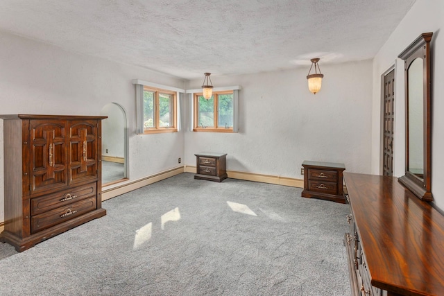60 Wheatfield Ln, Commack, NY 11725 - carpeted bedroom featuring a baseboard radiator and a textured ceiling