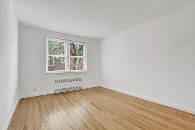 123-25 82nd Ave Unit 5R, Kew Gardens, NY 11415 - empty room featuring radiator heating unit and light wood-type flooring