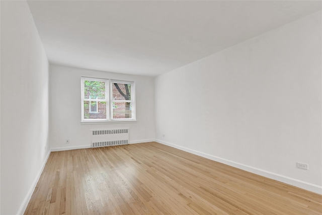 123-25 82nd Ave Unit 5R, Kew Gardens, NY 11415 - unfurnished room featuring light wood finished floors and radiator