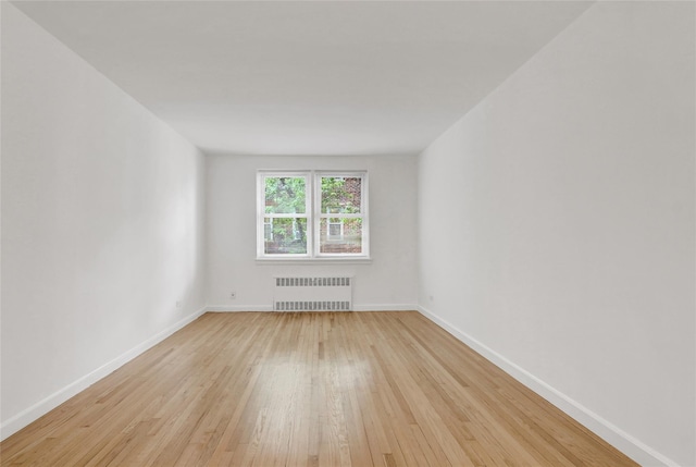 123-25 82nd Ave Unit 5R, Kew Gardens, NY 11415 - spare room with light wood finished floors and radiator heating unit