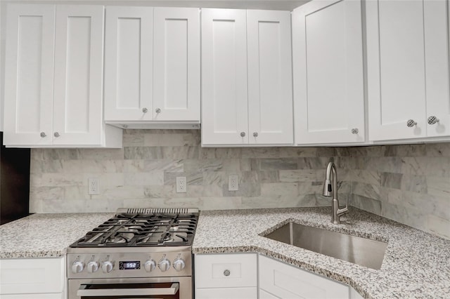 123-25 82nd Ave Unit 5R, Kew Gardens, NY 11415 - kitchen featuring stainless steel range with gas cooktop, white cabinetry, light stone counters, and decorative backsplash