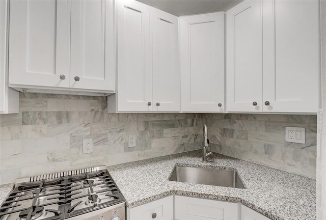 123-25 82nd Ave Unit 5R, Kew Gardens, NY 11415 - kitchen with stove, tasteful backsplash, white cabinets, and light stone counters