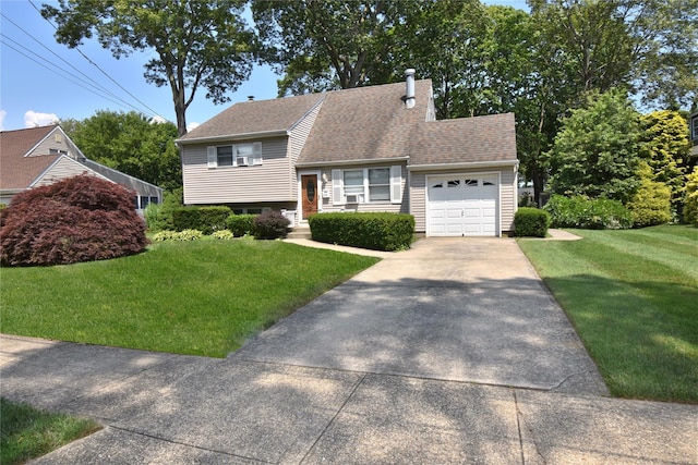 43 Circuit Rd, Bellport, NY 11713 - split level home featuring concrete driveway, a garage, a front yard, a chimney, and a shingled roof