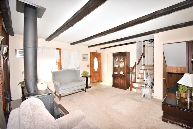43 Circuit Rd, Bellport, NY 11713 - living room featuring carpet floors, stairway, beam ceiling, and a wood stove