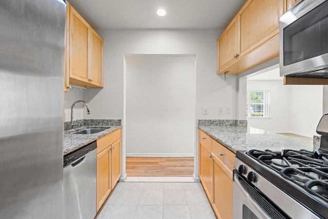 APTA2-22 Constitution Pl Unit 167, College Point, NY 11356 - kitchen with appliances with stainless steel finishes, light stone counters, light tile patterned floors, light brown cabinets, and recessed lighting