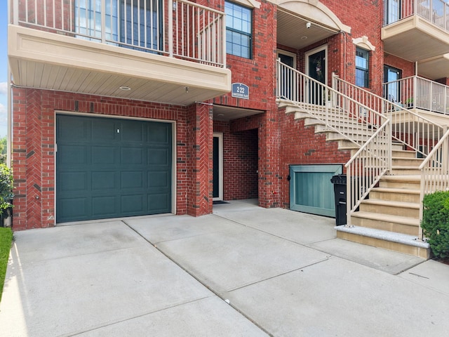 APTA2-22 Constitution Pl Unit 167, College Point, NY 11356 - property entrance with an attached garage, brick siding, and concrete driveway