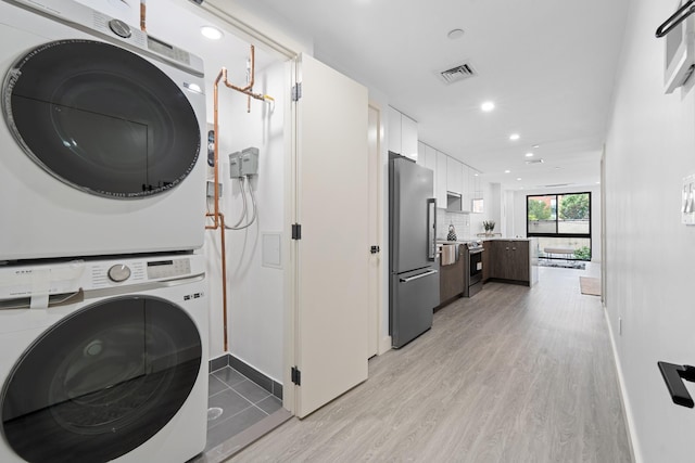 46-40 Vernon Blvd Unit 2B, Long Island City, NY 11101 - washroom with stacked washer / dryer, light wood-type flooring, and recessed lighting