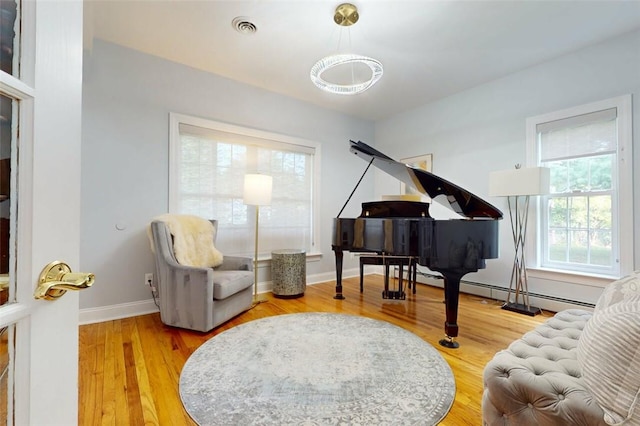9 Roselawn Rd, Highland Mills, NY 10930 - living area with plenty of natural light, wood finished floors, and a chandelier