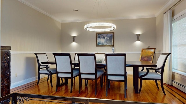9 Roselawn Rd, Highland Mills, NY 10930 - dining room with wood finished floors, a baseboard heating unit, and ornamental molding