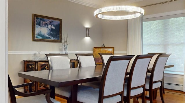 9 Roselawn Rd, Highland Mills, NY 10930 - dining space with wood finished floors, crown molding, and baseboard heating