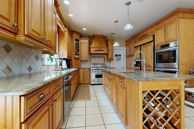 9 Roselawn Rd, Highland Mills, NY 10930 - kitchen featuring stainless steel appliances, premium range hood, light tile patterned flooring, an island with sink, and light stone countertops