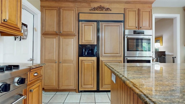 9 Roselawn Rd, Highland Mills, NY 10930 - kitchen featuring double oven, paneled fridge, light stone countertops, light tile patterned floors, and range